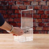 A clear Acrylic donation / ballot box showcases how to open box