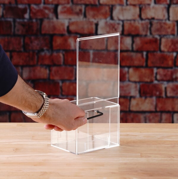 A clear Acrylic donation / ballot box showcases how to open box